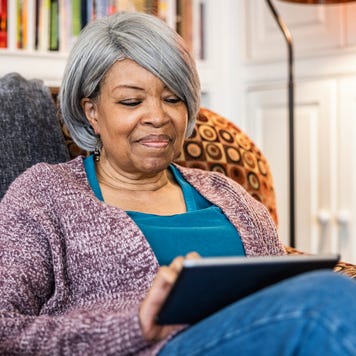 Senior woman using digital tablet in home environment