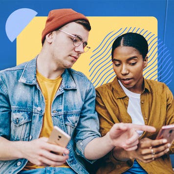 Two young adults have a conversation about something on a cellphone