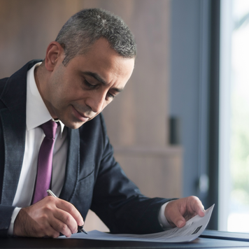 Judge or Legal advisor lawyer examining and signing legal documents.