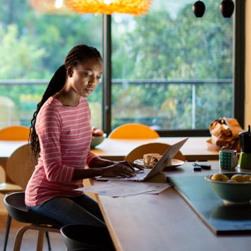 Woman working on her laptop at home