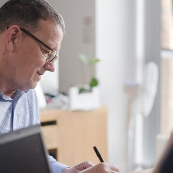 Male colleagues in discussion at office desk