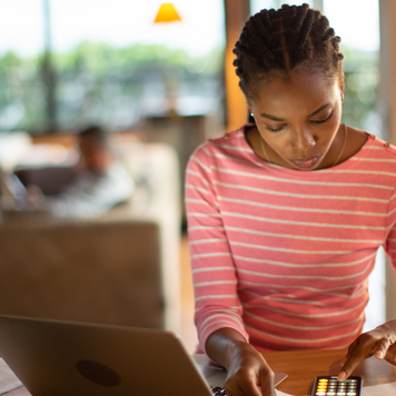 Woman doing taxes at her computer.