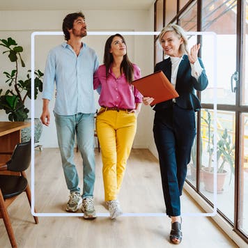 a couple touring a home with a professional real estate broker