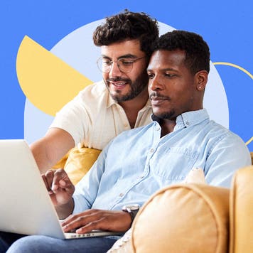 Two men looking at a laptop