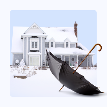 home with snow-covered roof in background, umbrella in foreground