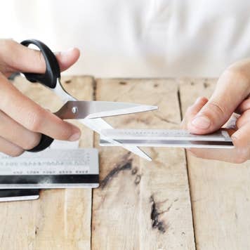Person cutting up a credit card with scissors