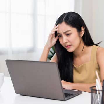 Young woman very focused on a laptop, home office