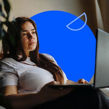 Young woman using a laptop on a couch