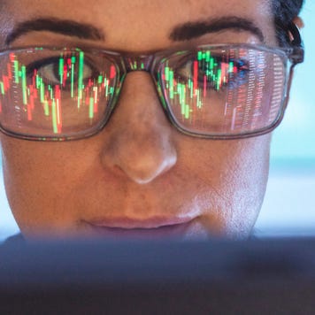 Stockbroker analyzing financial stock market with reflection on eyeglasses
