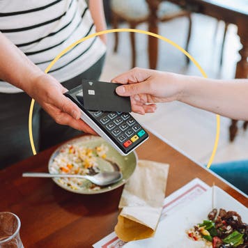 Someone paying for their meal by credit card