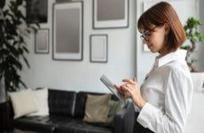 businesswoman chatting on digital tablet in office interior