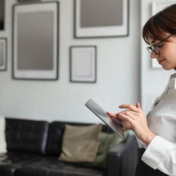 businesswoman chatting on digital tablet in office interior