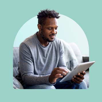 Smiling man using a tablet