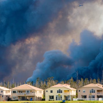 Houses against backdrop of smoke from wildfires