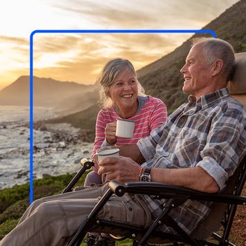 Older couple enjoying the beach as dawn breaks