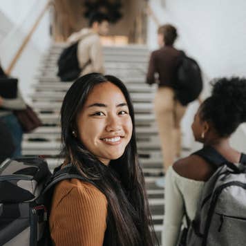 Portrait of smiling female student at university