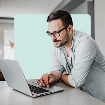 Man using laptop in kitchen