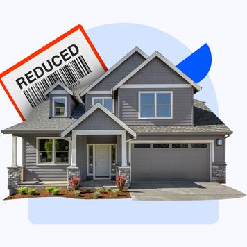 A house with a sign that says "Reduced" behind it