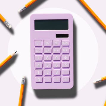 Pink calculator surrounded by pencils.