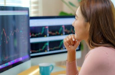 Woman Trading Stocks or Cryptocurrency at Home
