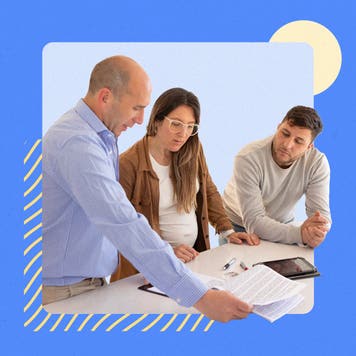 Three people looking over paperwork