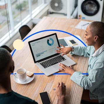 Two people reviewing a graph