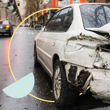 Car with a wrecked rear bumper in city street