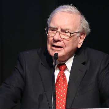 Warren Buffett speaks into a microphone.