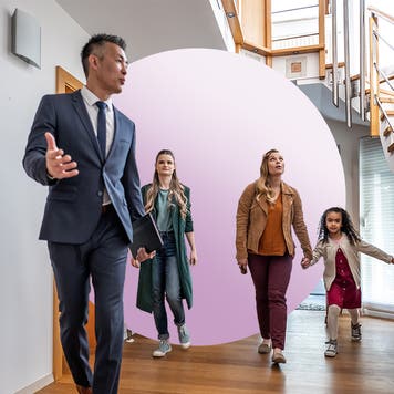 Realtor showing family house with modern stairs