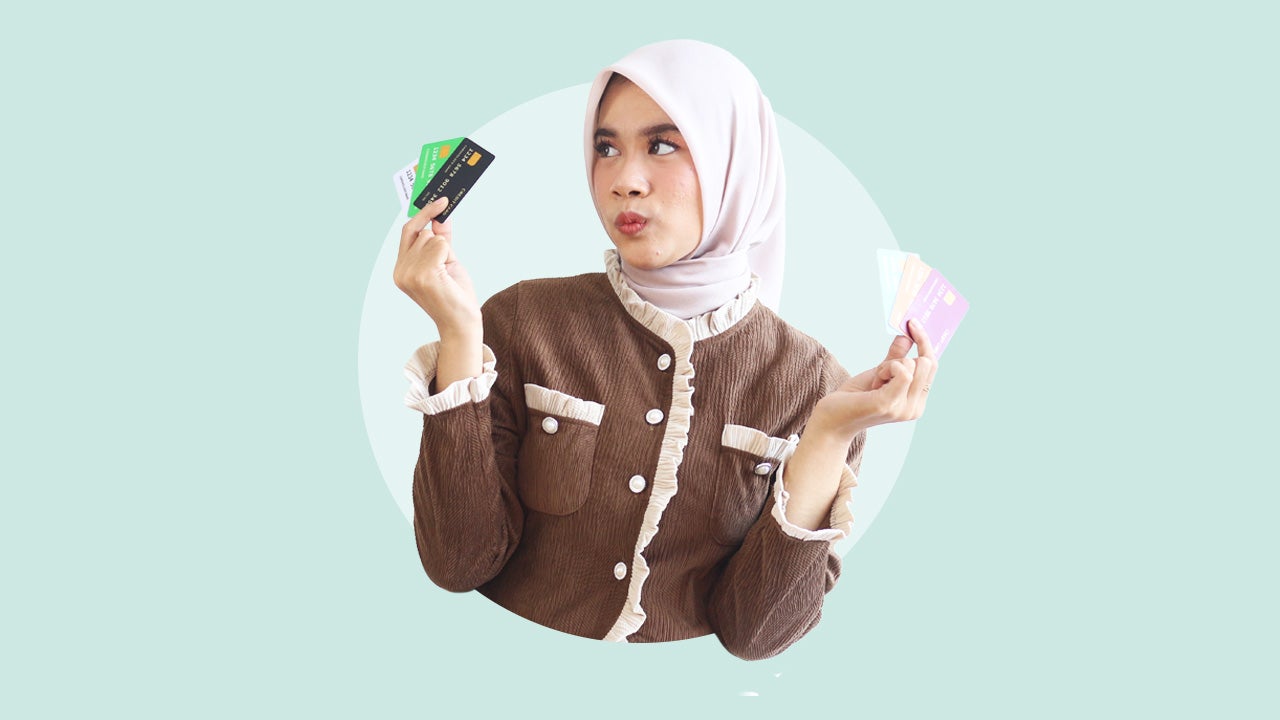 Design element of a person holding several credit cards in each hand.