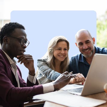 People reviewing content on a laptop