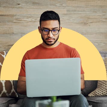 Man works on laptop. Behind him is an image of a yellow half circle overlaid on the photograph's background.