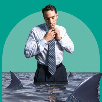 Man adjusting his tie while standing in water