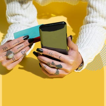 Design element of hands holding a phone and credit cards