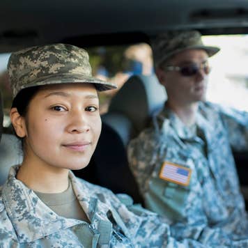 asian woman and white man in military uniform inside a car