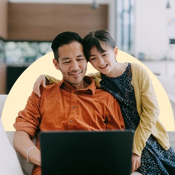 Child with parent looking at laptop