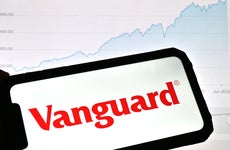 photo illustration, a Vanguard logo is displayed on a smartphone