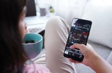 Woman invest online stocks trading on mobile platform app