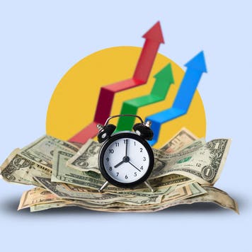 Analog alarm clock sitting on a stack of cash