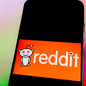 The Reddit logo appears on a phone screen