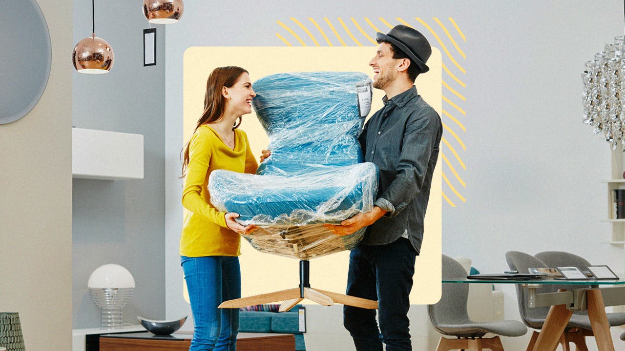 Two people carrying furniture