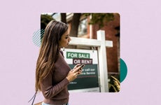 Woman on cell phone standing in front of a home for sale sign