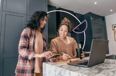 two women looking to buy a house online