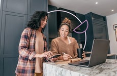 two women looking to buy a house online