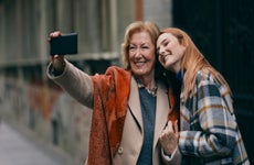 Grandmother taking selfie of her and her granddaughter