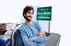 Driver leaning against their car in Alabama