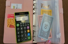 Pocketbook, calculator, and monopoly game money
