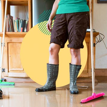 A person standing in boots after a flood.