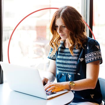 Woman typing on a laptop.