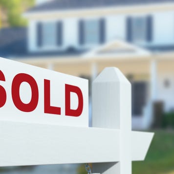 Sold For Sale Real Estate Sign in Front of New House.